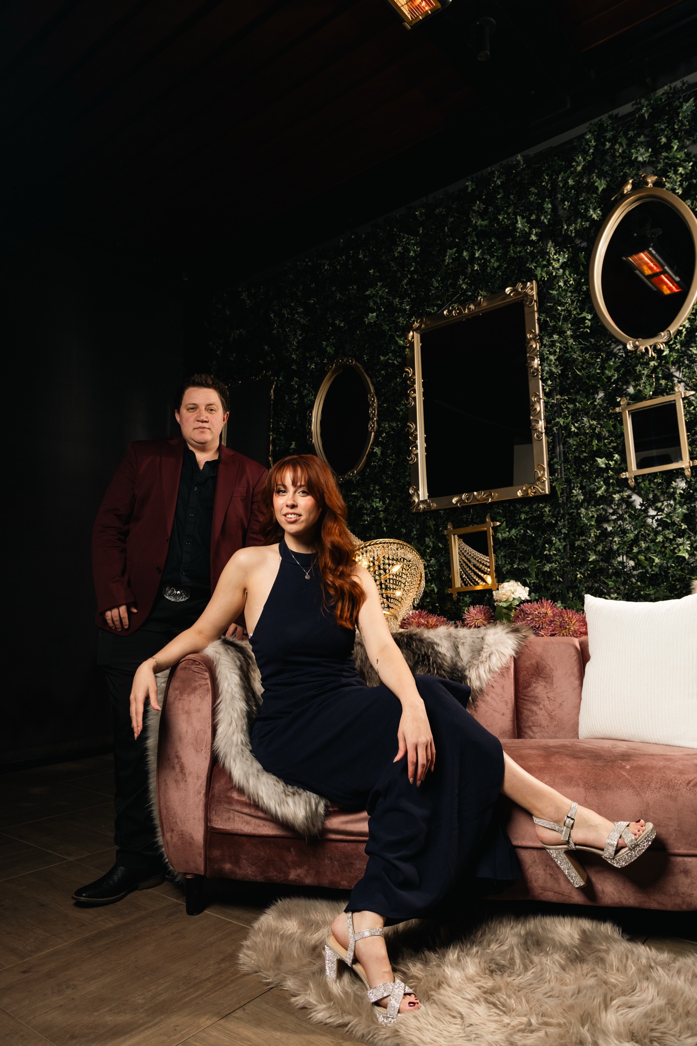 Bailey and Charley Lavender on the pink velvet couch before the mirror wall