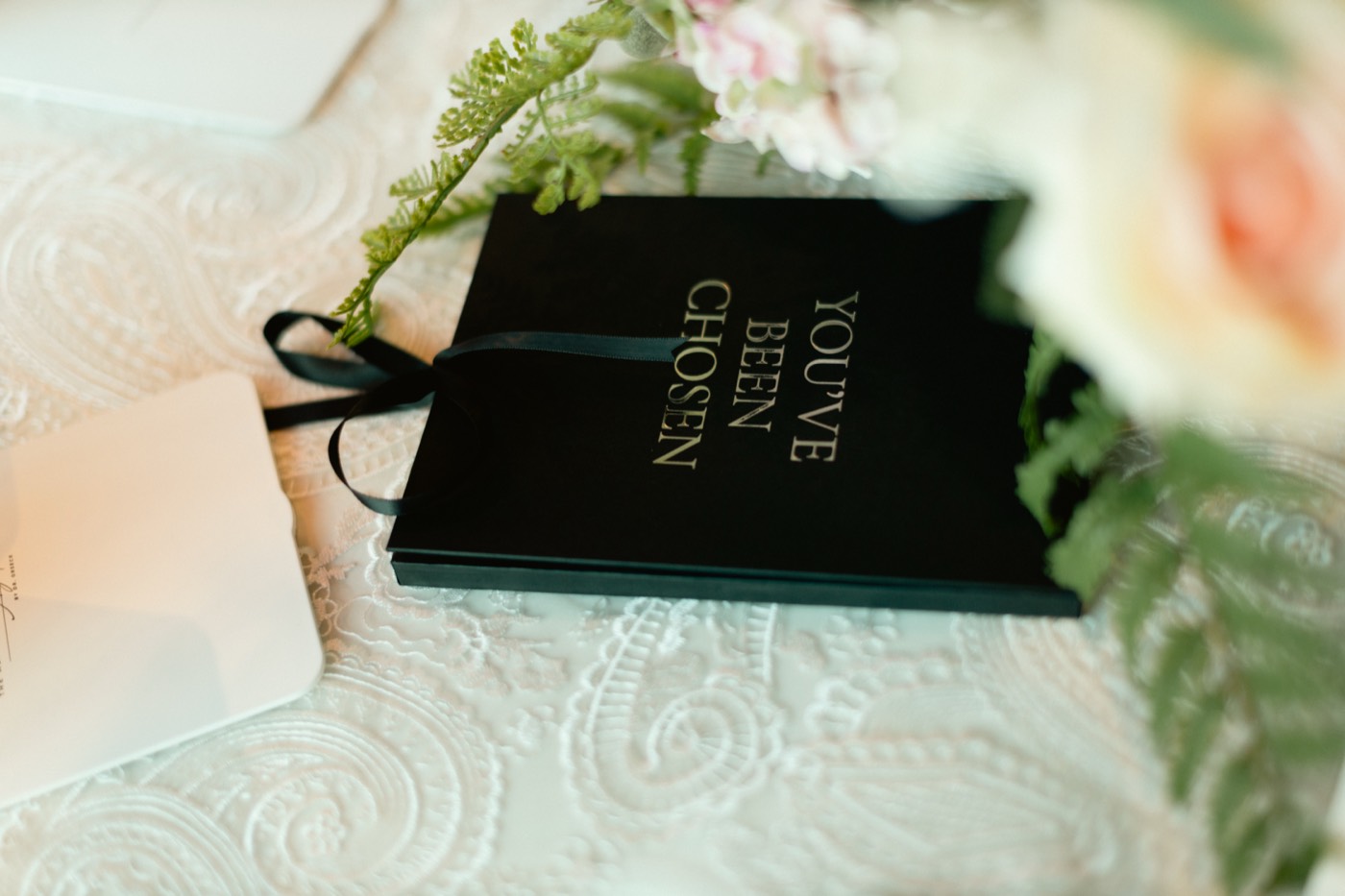 Black gift box reading YOU'VE BEEN CHOSEN in gold foil