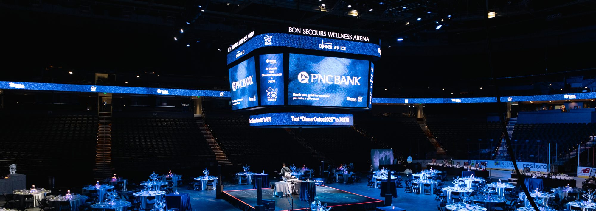 An arena floor set for a gala at Bon Secours Wellness Arena
