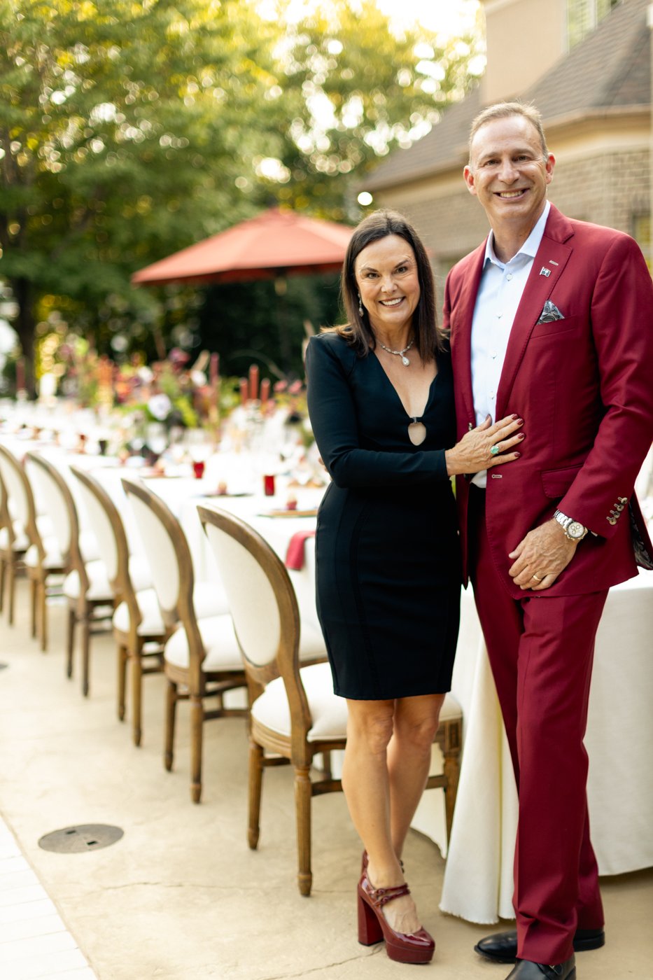 Tiffany and Melvin, the hosts, beside the table